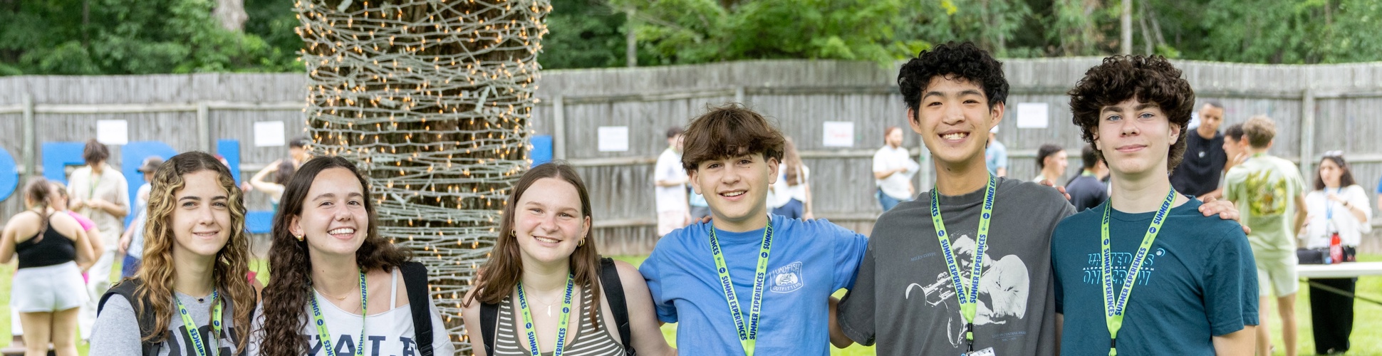 Un grupo de jóvenes de diferentes orígenes sonriendo en un evento comunitario