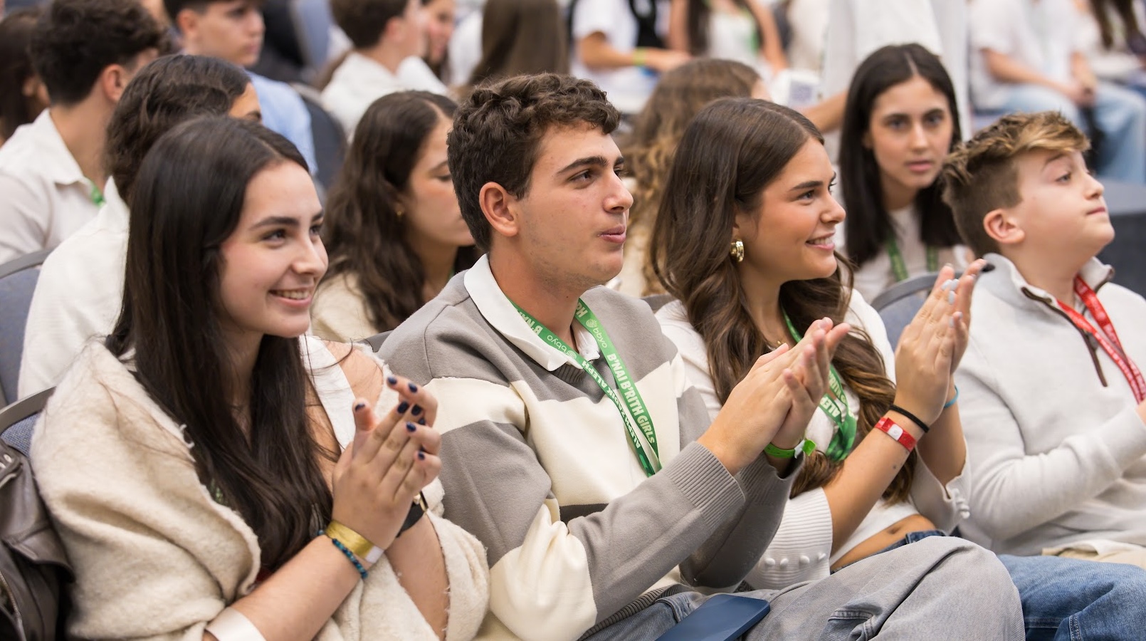 Un grupo de jóvenes de diferentes orígenes sonriendo en un evento comunitario
